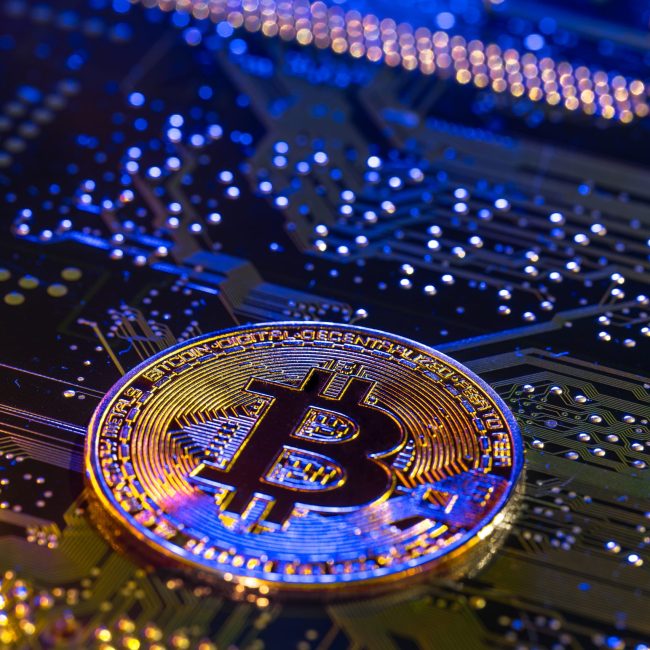 Bitcoin coin close-up on circuit board. Finance concept. Digital currency concept showing Bitcoin and crypto exchange in Dubai crypto exchange dubai